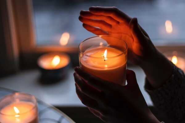 person holding lighted candle