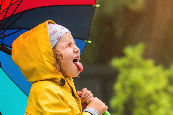 Little girl sticking her tongue out in the rain