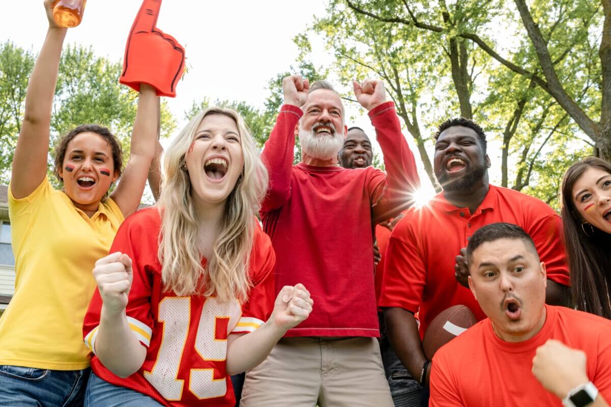 Football fans celebrating at a tailgate