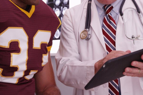 Football player talking to a doctor