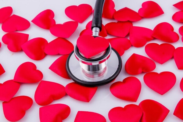 A stethoscope surrounded by hearts
