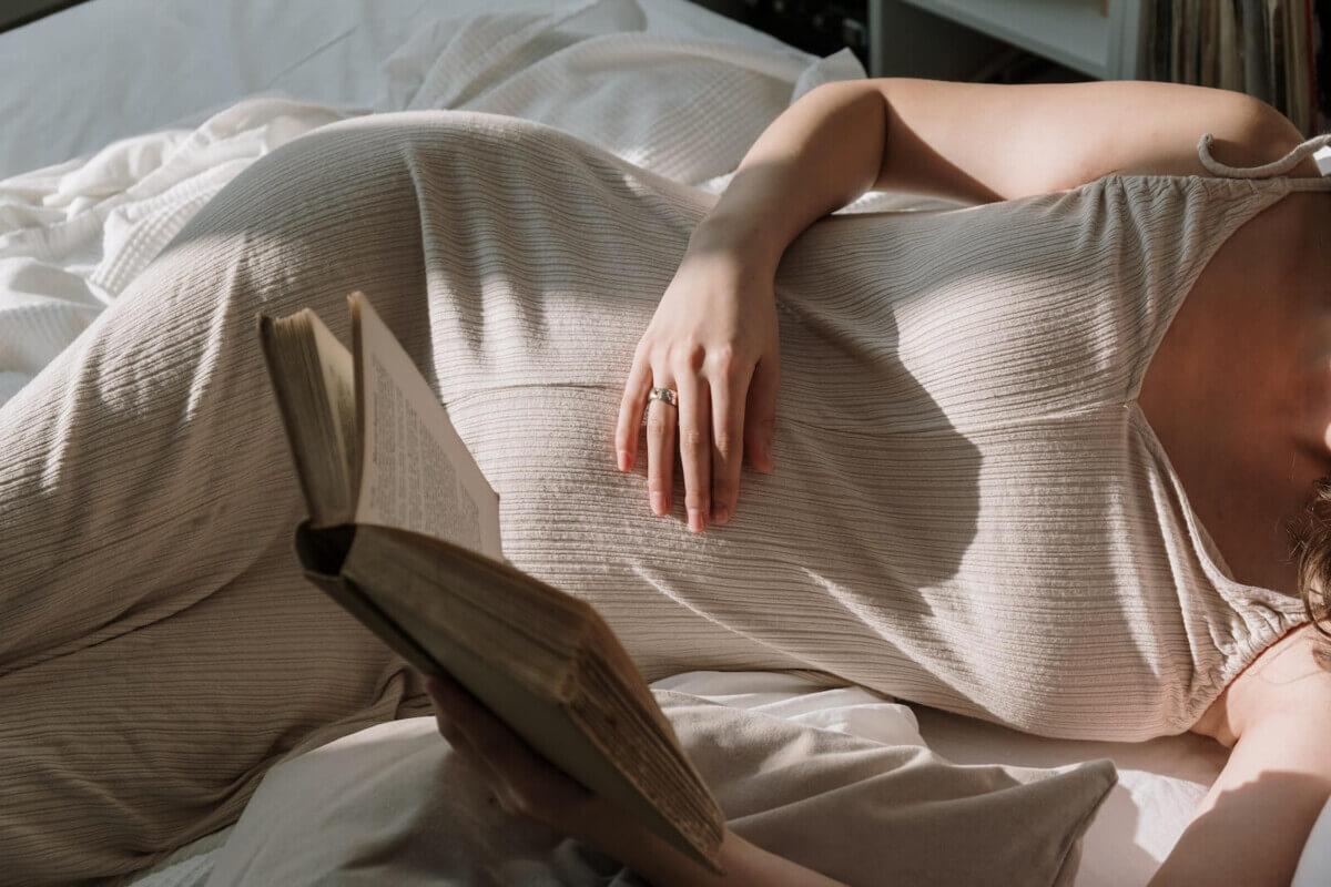 A pregnant woman reading a book