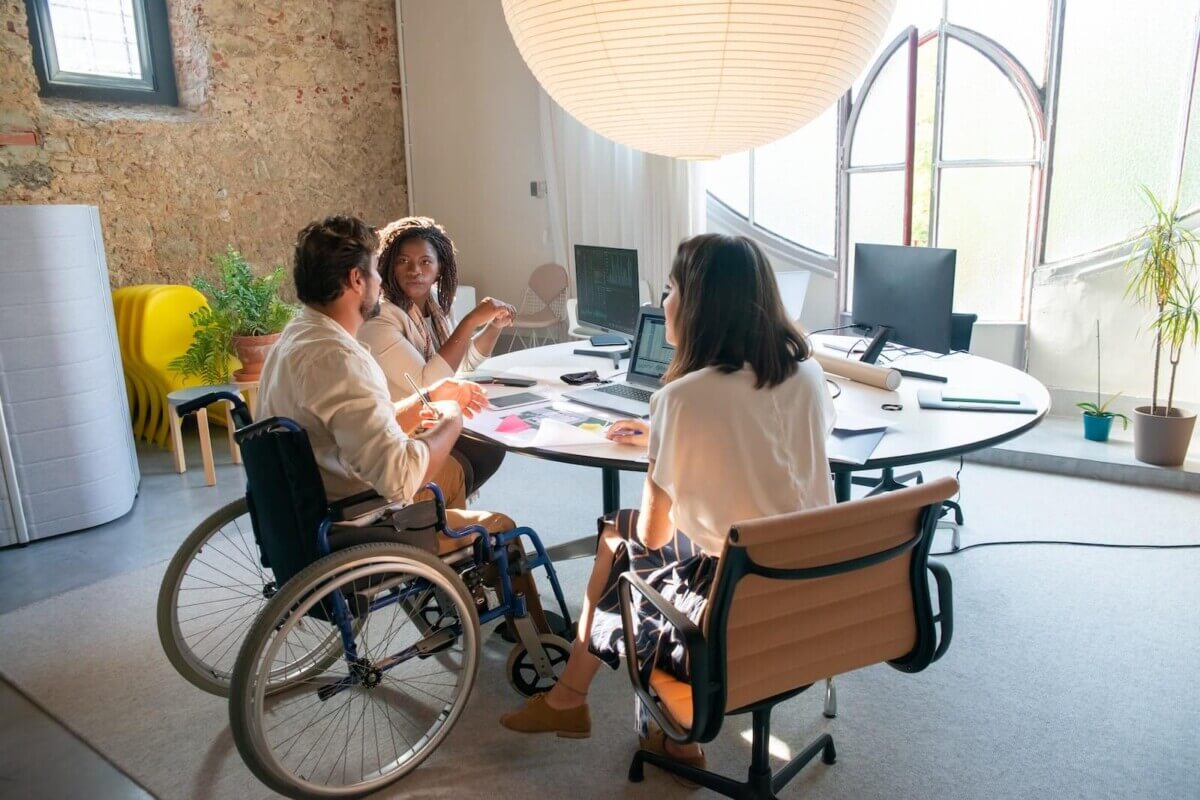 Person in wheelchair at office Meeting
