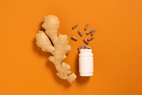 Fresh ginger root jar with vitamin pills