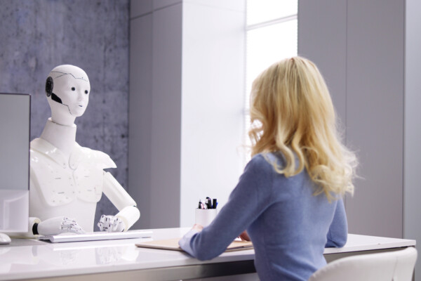 Woman at Interview With AI Robot Machine