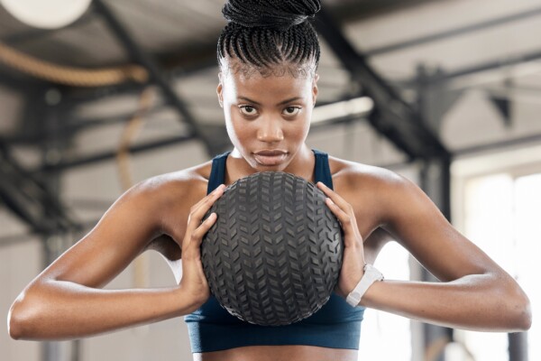 A woman working out with a medicine ball