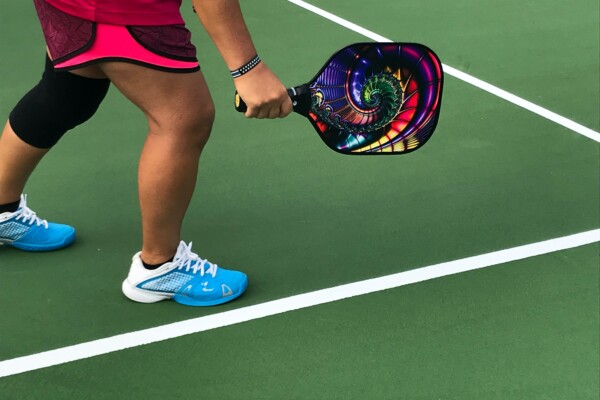 A woman playing pickleball