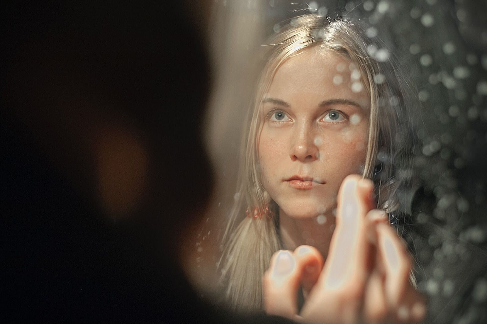 Woman looking at herself in the mirror