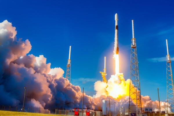 white and red space ship on blue sky during daytime