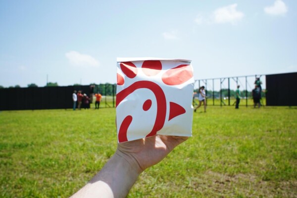 person holding white and red box