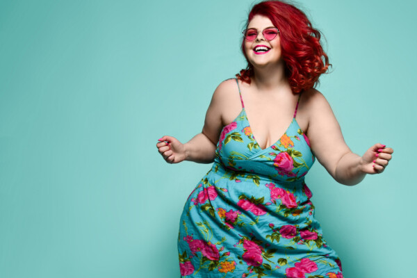 A happy, stylish woman dancing