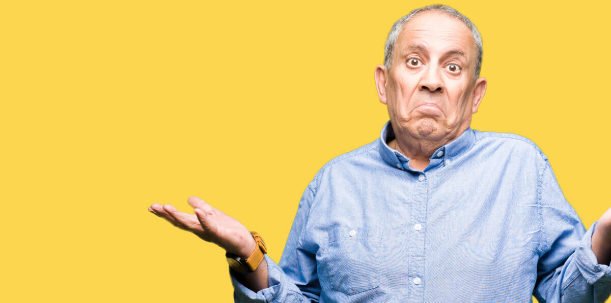 A senior man shrugging
