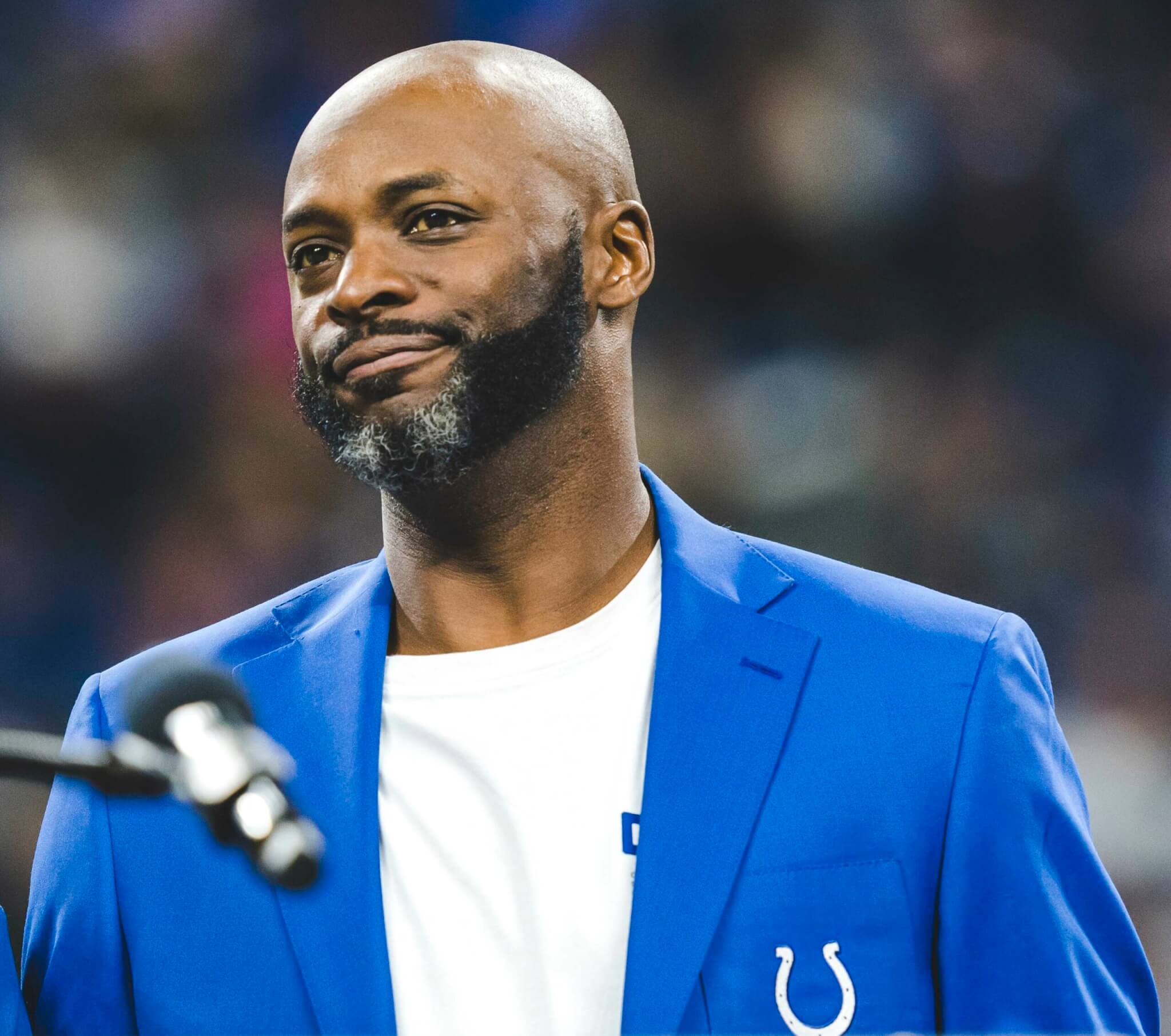 Reggie Wayne in his Colts blazer giving a speech