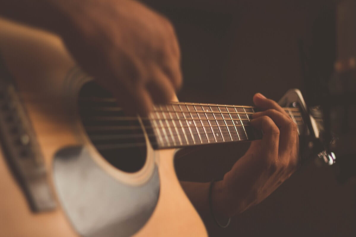 Someone playing the acoustic guitar