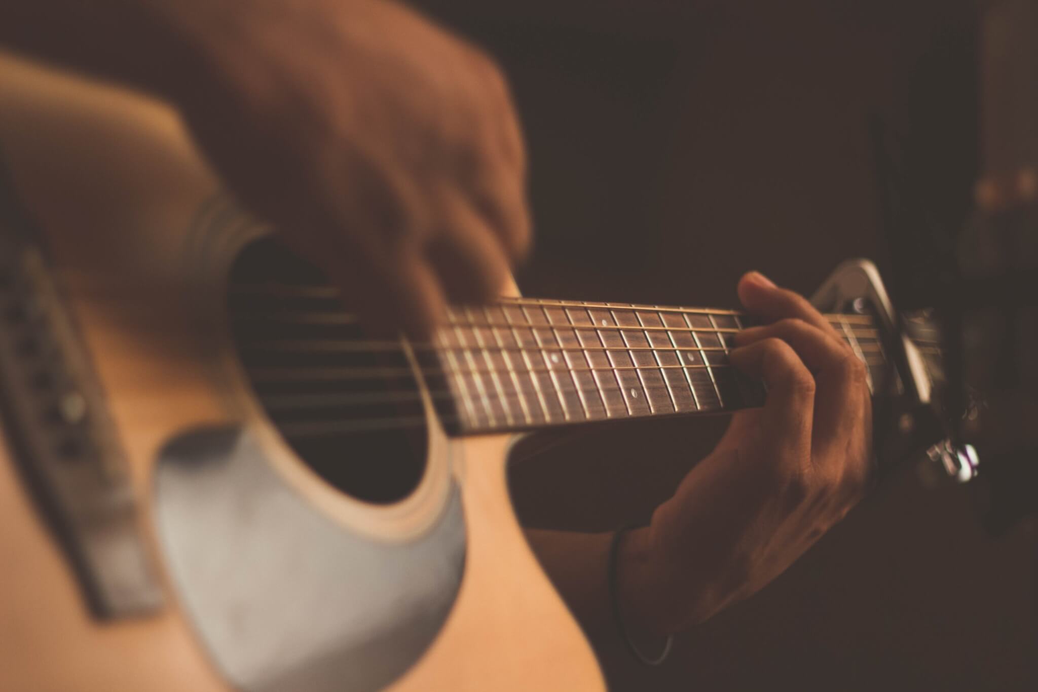Someone playing the acoustic guitar