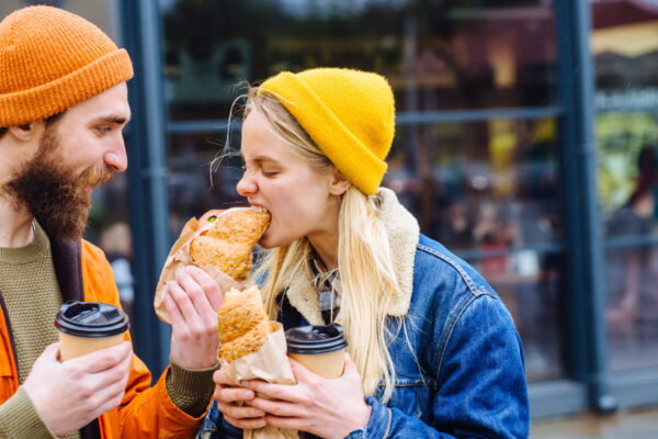 Hungry couple eating fast food