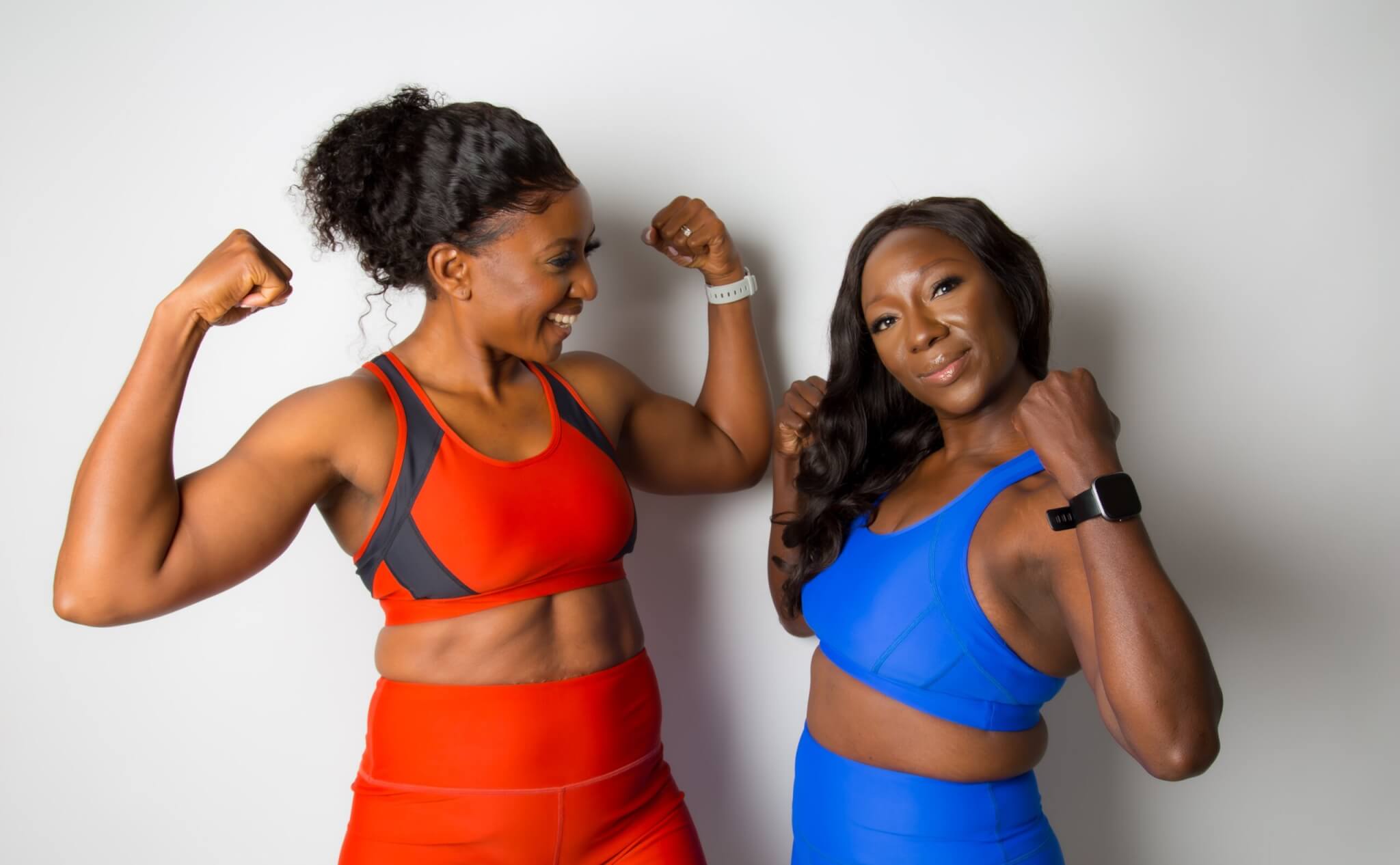 Two women wearing sports bras and leggings