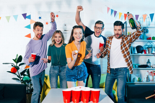 Friends playing beer pong
