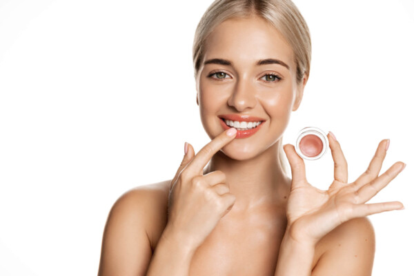 A woman applying a lip mask
