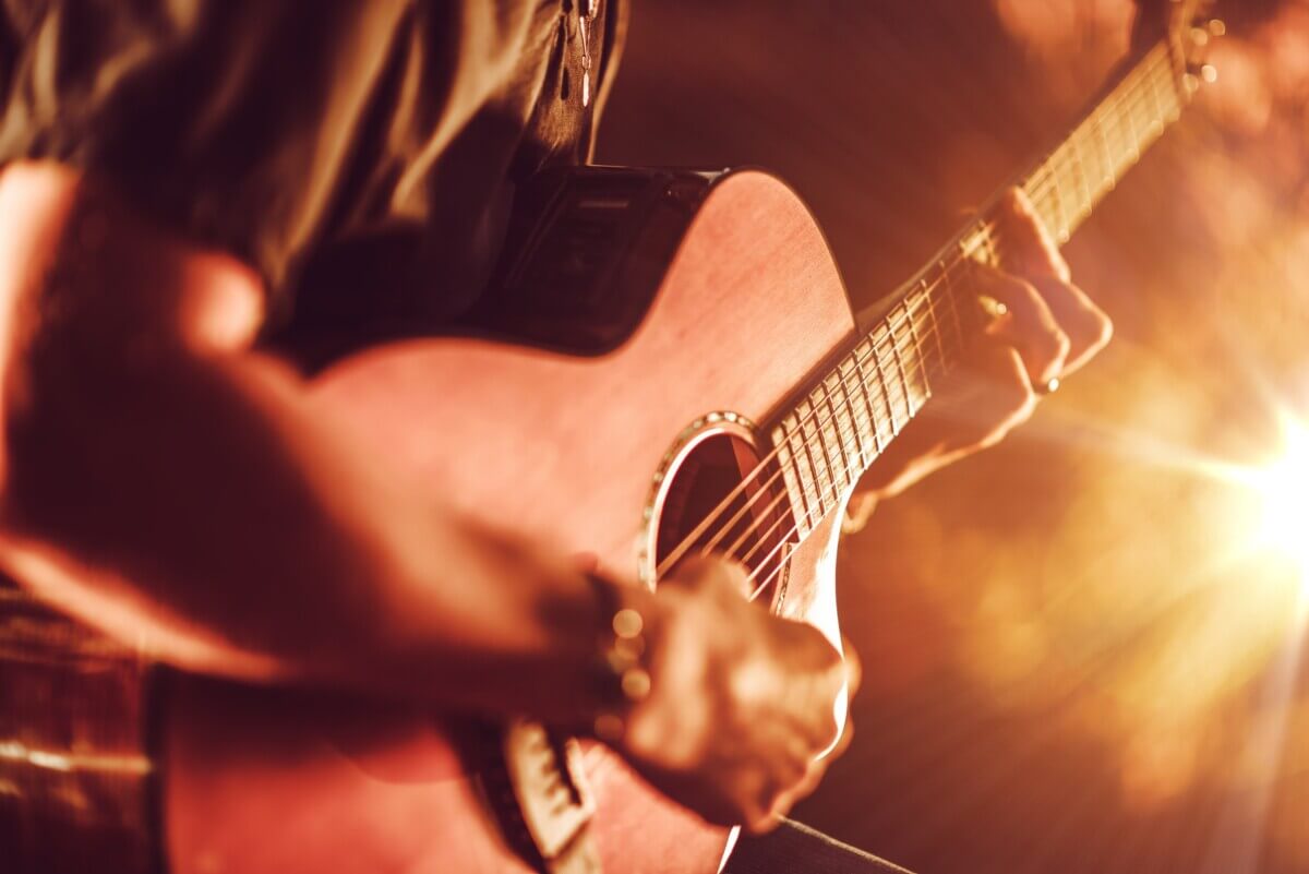 A man playing the acoustic guitar