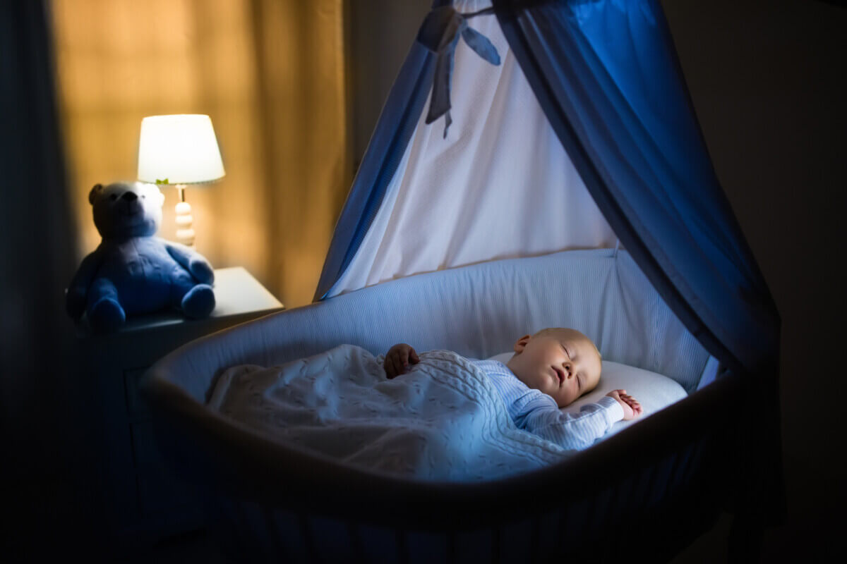 A baby sleeping in a bassinet