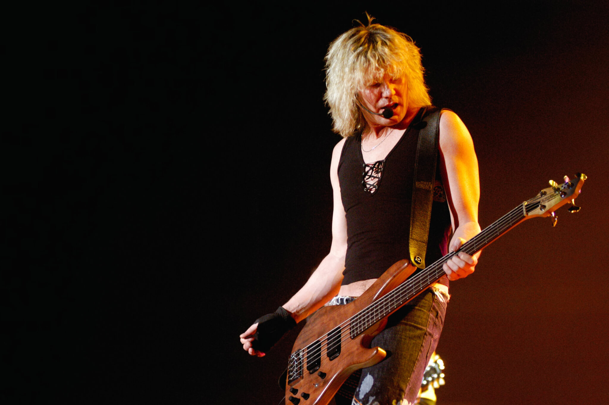 Def Leppard bassist Rick Savage performing in 2002