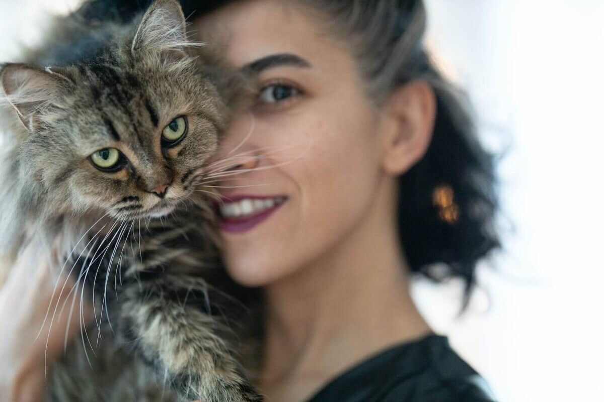 Woman Carrying Brown Cat