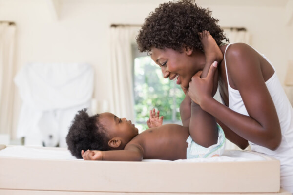 A mother changing her baby's diaper