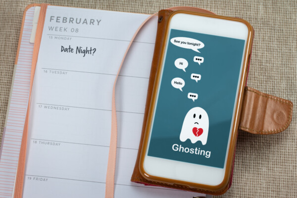 Ghosting on mobile phone on table with diary