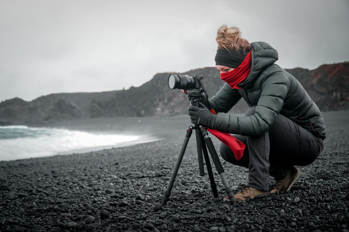 A photographer using a camera tripod
