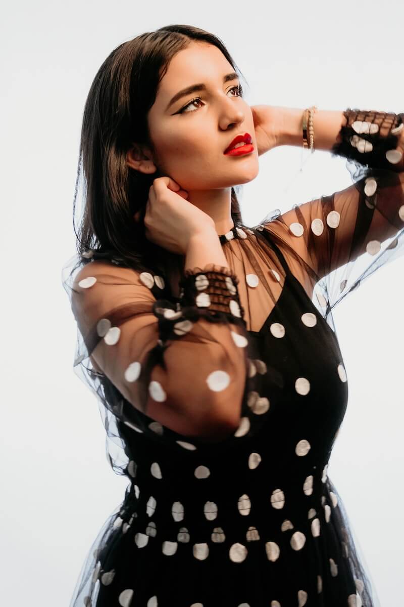 woman in black and white polka dot shirt