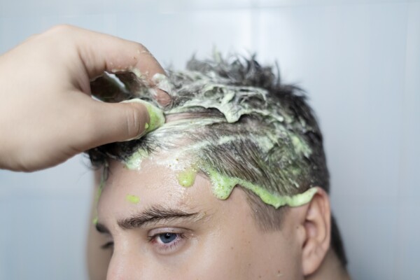 A man using a scalp scrub