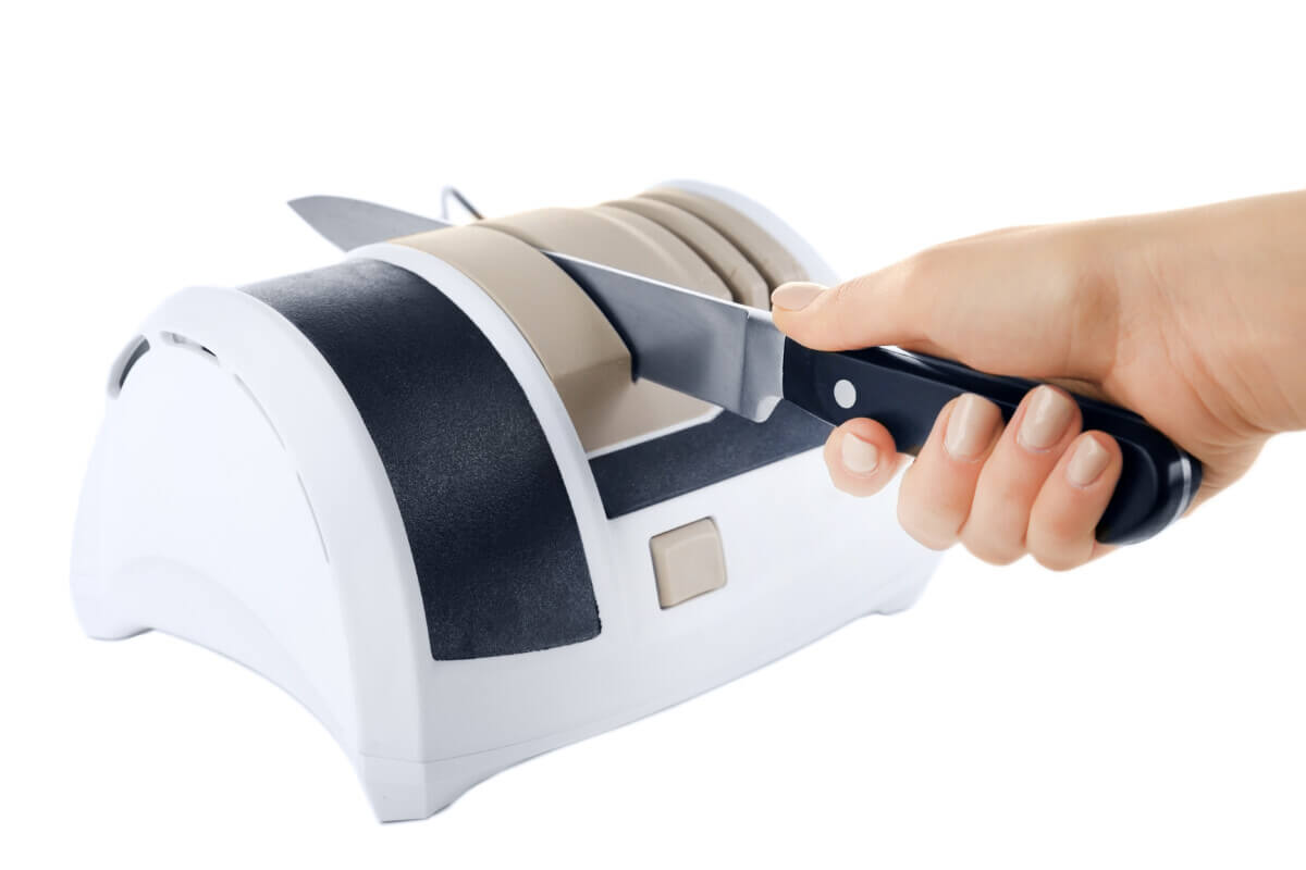 Someone using an electric knife sharpener