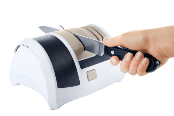 Someone using an electric knife sharpener