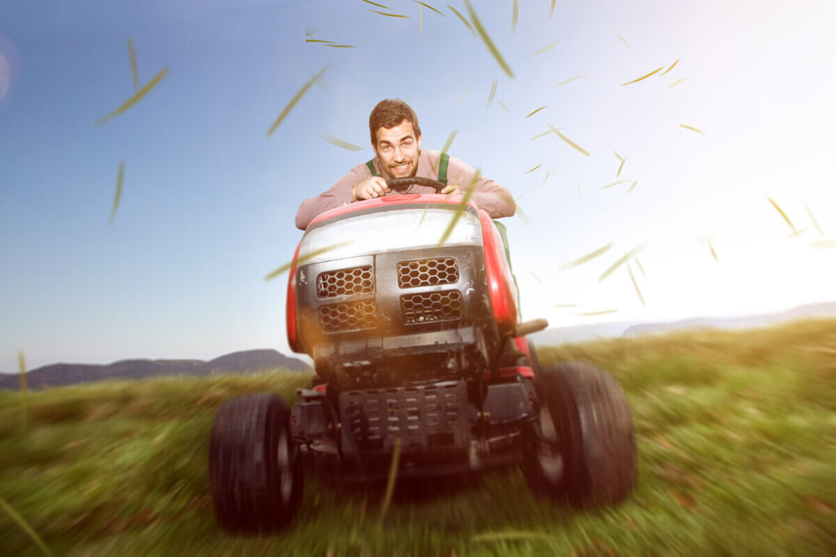 A man on a riding lawn mower