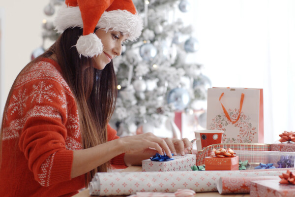 Woman wrapping Christmas gifts