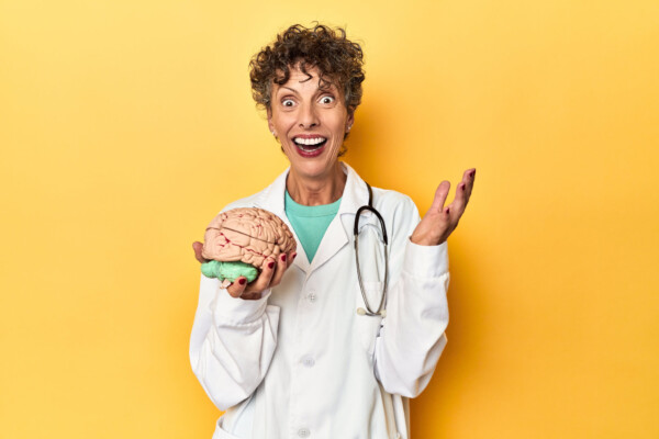 Surprised doctor holding a brain model
