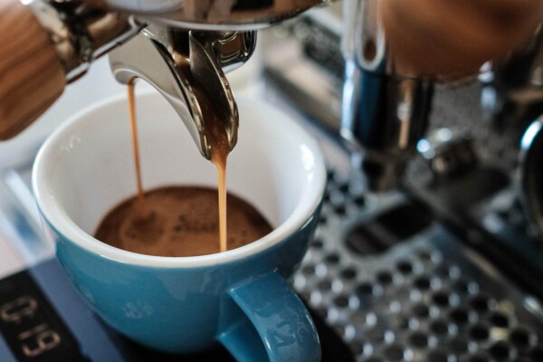 blue ceramic mug on silver espresso machine