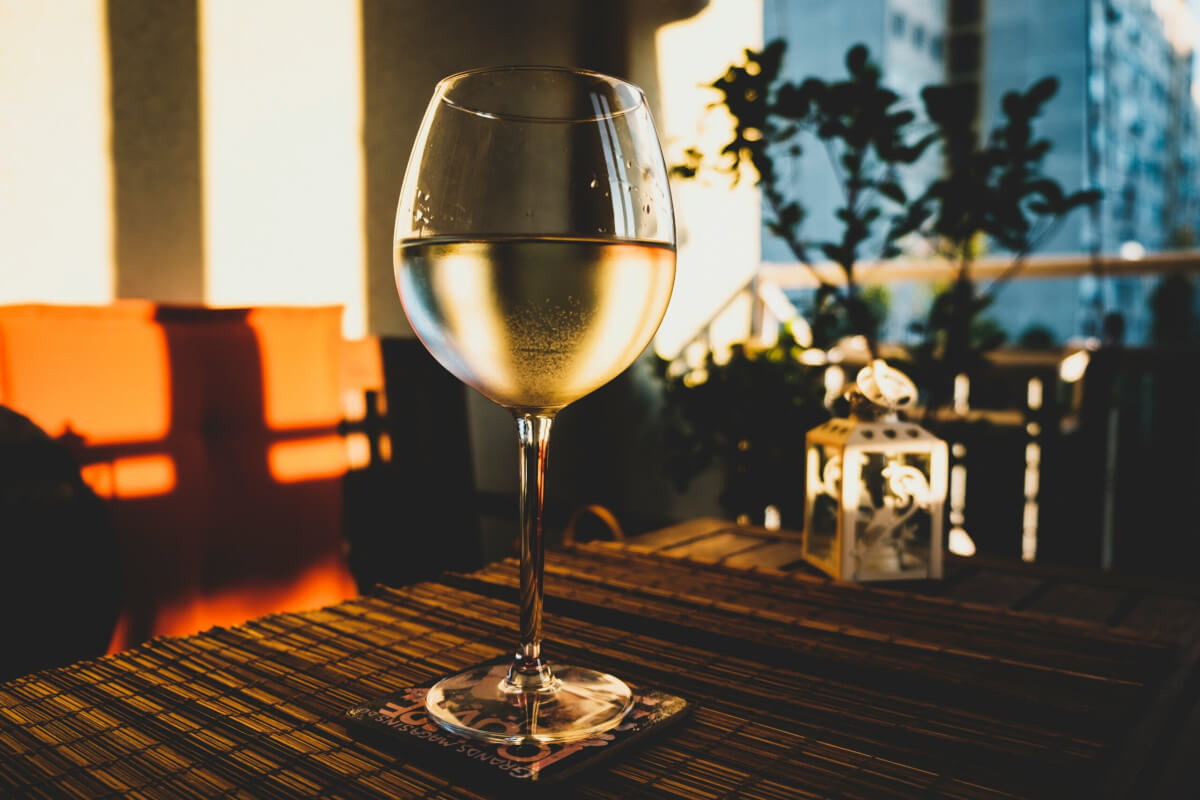 A glass of white wine on a dinner table