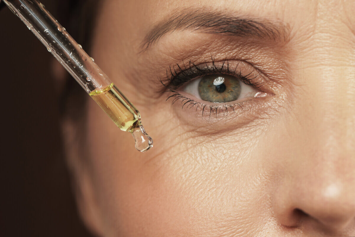 A woman applying anti-aging serum