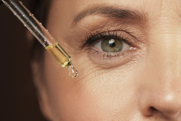 A woman applying anti-aging serum