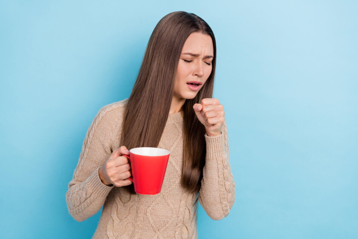 A woman drinking tea for a cough