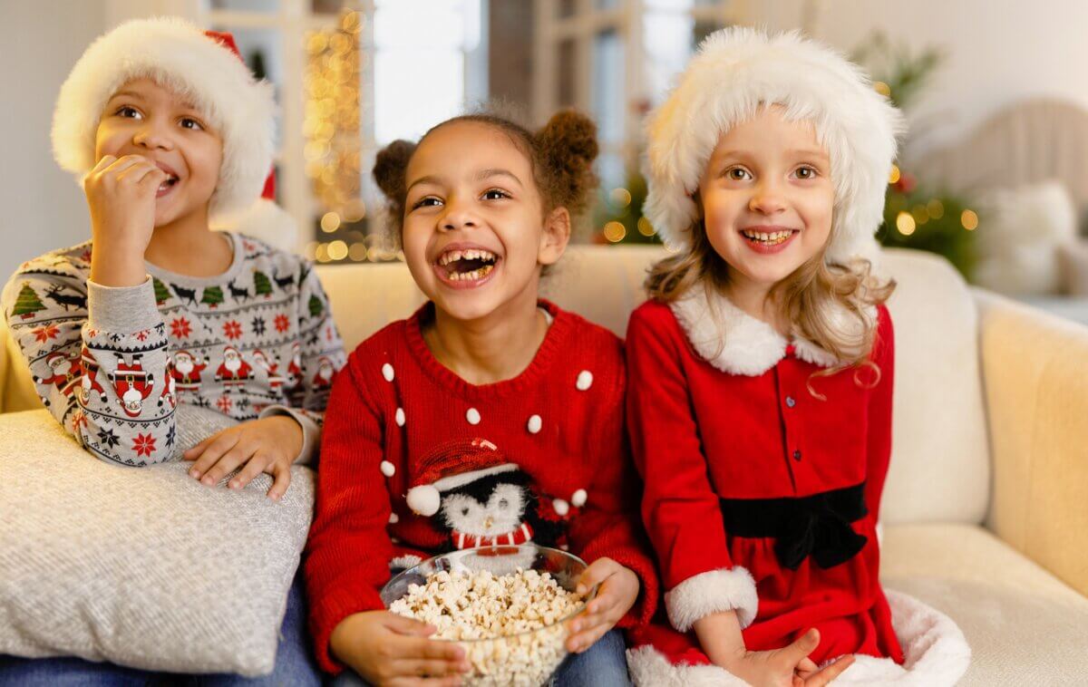 Children laughing as they watch a Christmas movie