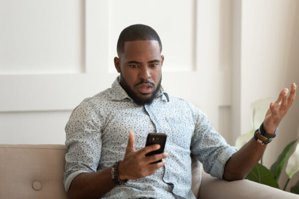 A man experiencing FOMO on social media
