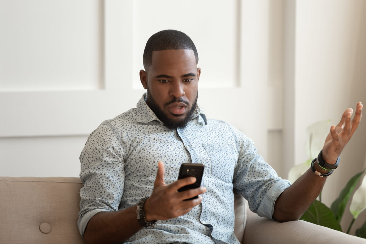 A man experiencing FOMO on social media