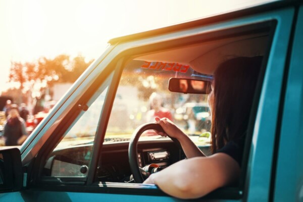 Woman driving with window down