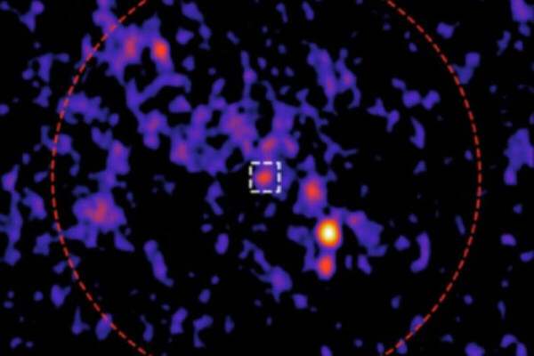The team identified a new radio source (white square) in the center of the cluster (red circle).