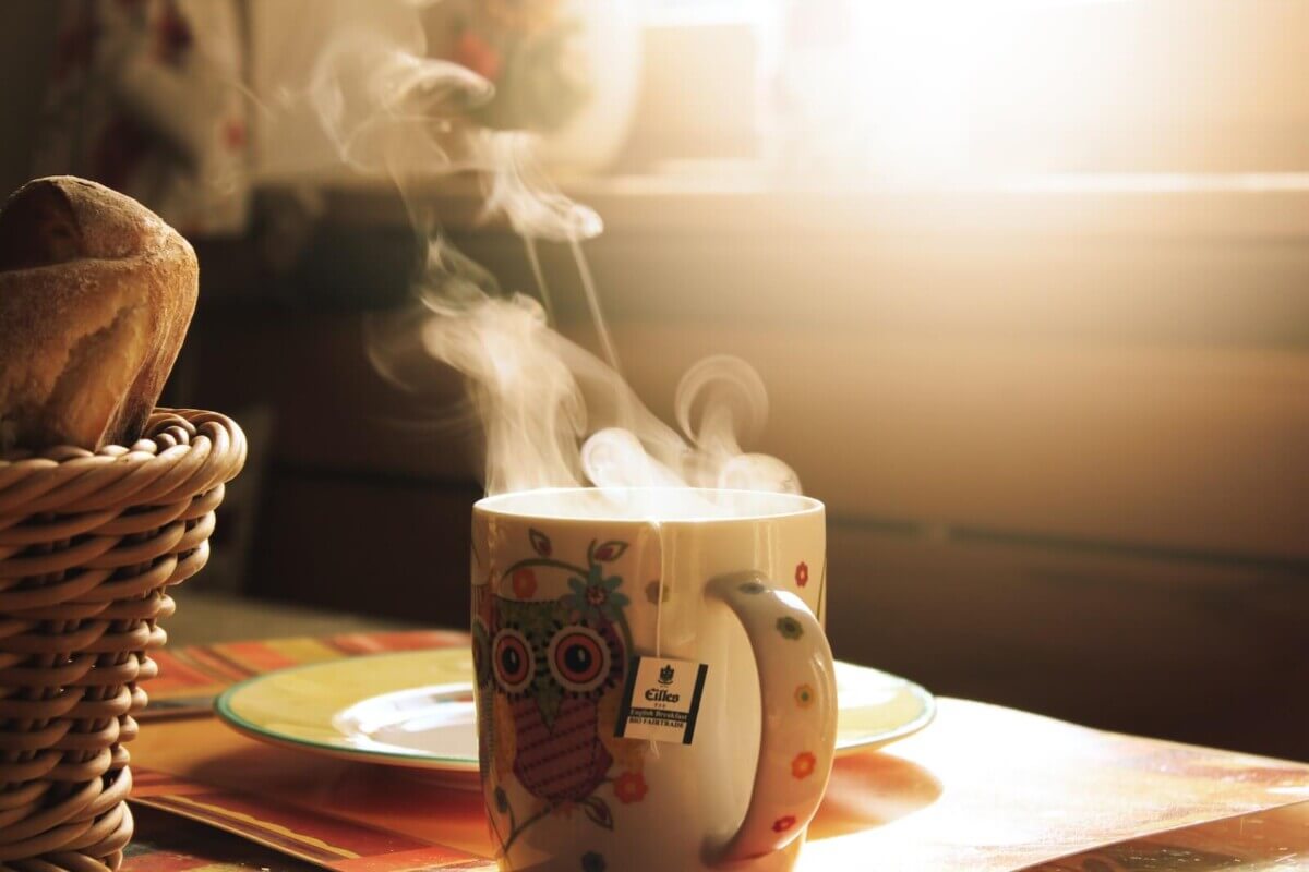 Green and white mug with tea