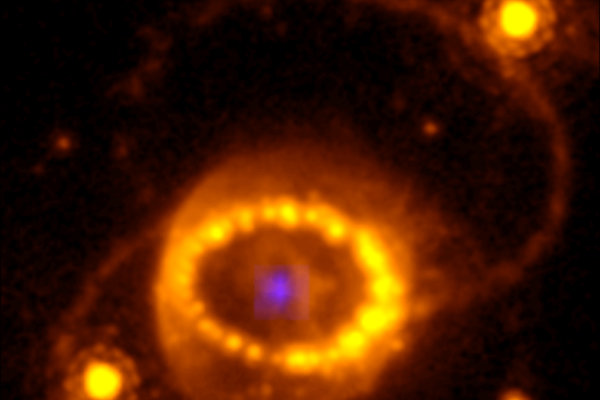 Combination of a Hubble Space Telescope image of SN 1987A and the compact argon source. The faint blue source in the centre is the emission from the compact source detected with the JWST/NIRSpec instrument. Outside this is the stellar debris, containing most of the mass, expanding at thousands of km/second. The inner bright “string of pearls” is the gas from the outer layers of the star that was expelled about 20,000 years before the final explosion. The is the fast debris are now colliding with the ring, explaining the bright spots. Outside of the inner ring are two outer rings, presumably produced by the same process as formed the inner ring. The bright stars to the left and right of the inner ring are unrelated to the supernova. (CREDIT: Hubble Space Telescope WFPC-3/James Webb Space Telescope NIRSpec/J. Larsson)