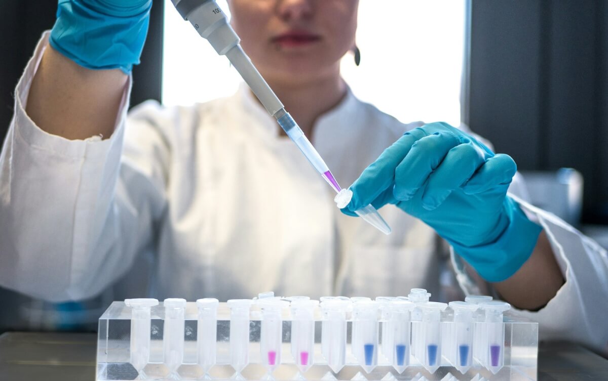 woman in lab holding vials